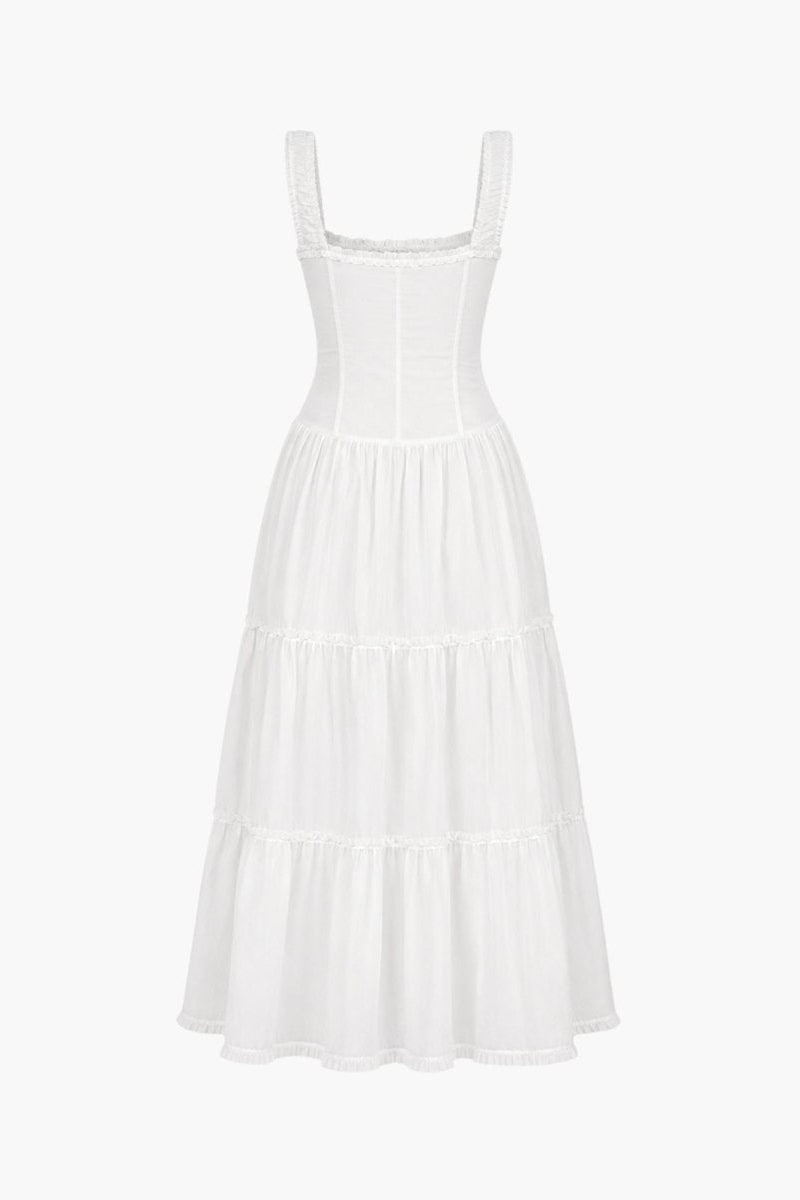 Flat lay back view of a luxury white summer sundress highlighting the structured waist seaming and tiered flowy skirt.