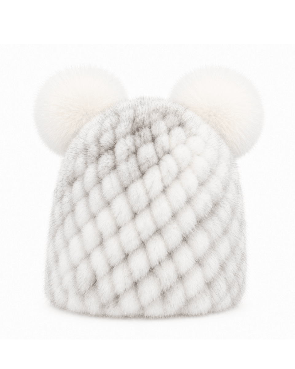 A white faux fur beanie hat featuring a textured diamond pattern and two fluffy pom-poms on top, shown against a plain white background.