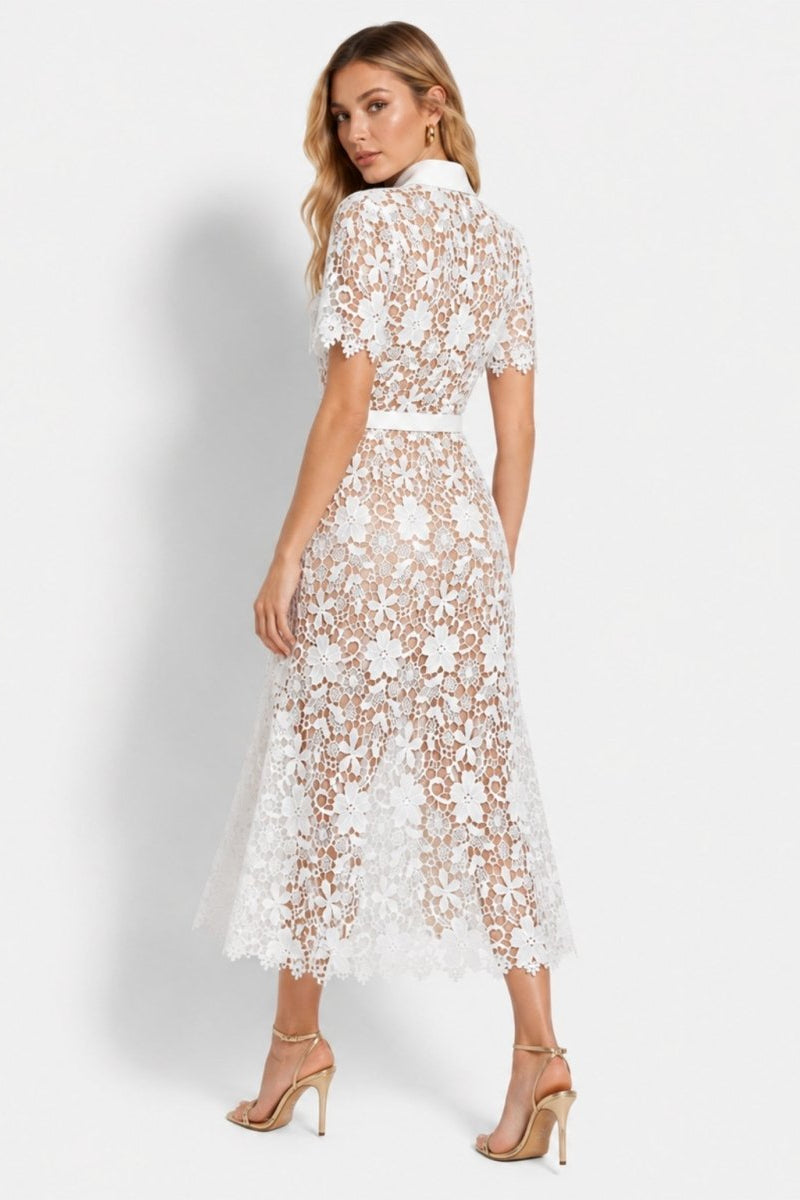 Back view of the white floral lace A-line dress showing the tailored fit, scalloped hemline, and delicate semi-sheer lace details.