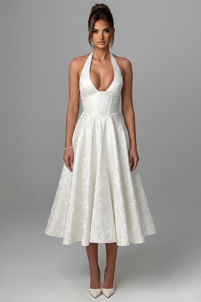 Front view of the Kouvr white halter corset midi dress featuring a plunging v-neckline and premium textured jacquard fabric.