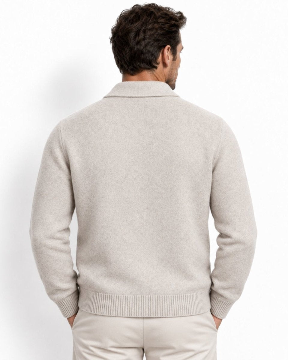 A man viewed from the back wearing a white knit sweater and matching trousers against a clean white studio background.