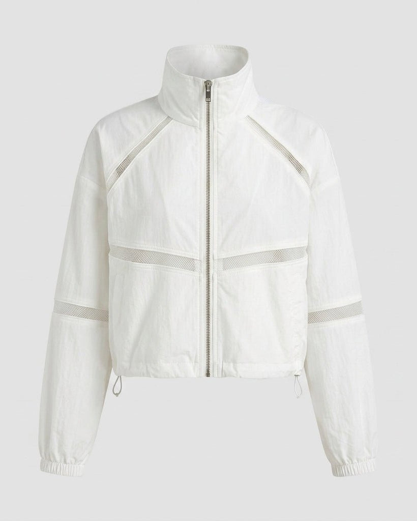 Flat product shot of the white funnel neck track jacket featuring a zip front and geometric mesh inserts