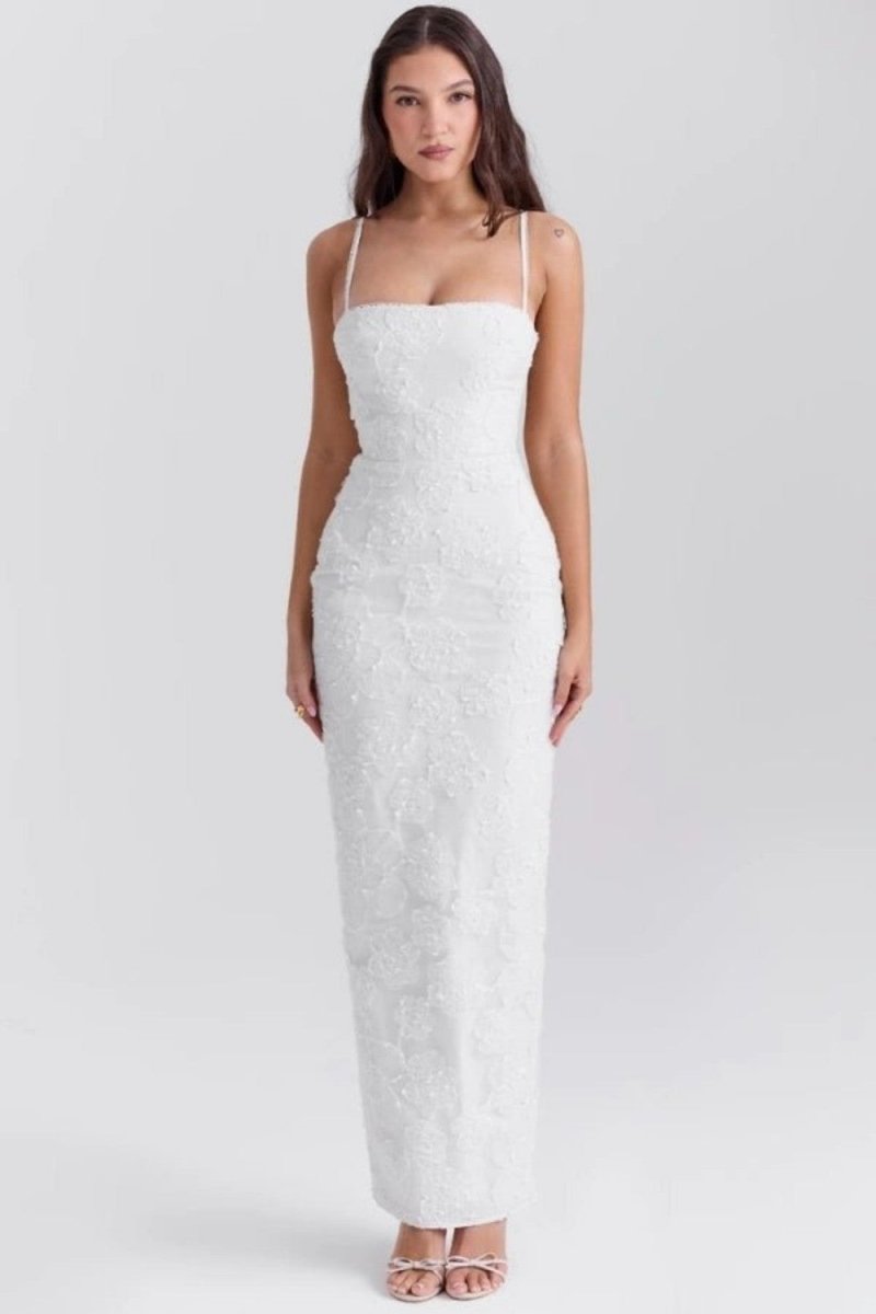 Woman wearing a white strapless dress on a light gray background