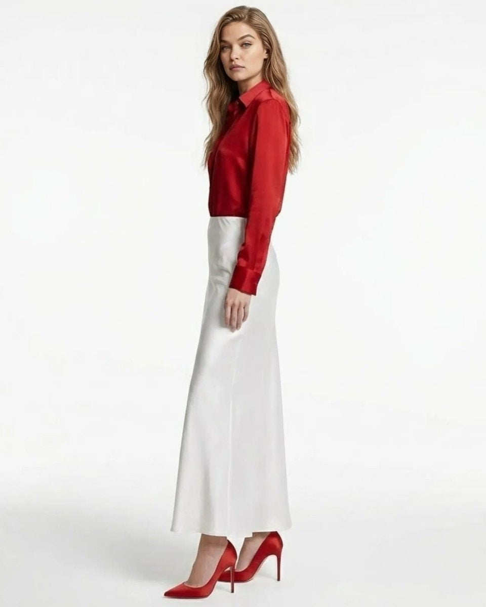 Side profile of the long white satin skirt showing the bias cut silhouette and ankle-length hem.
