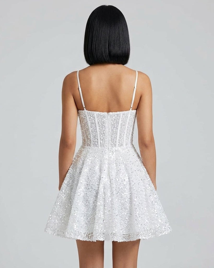 Back view of short white sequin fit and flare dress showing concealed back zipper and low back design