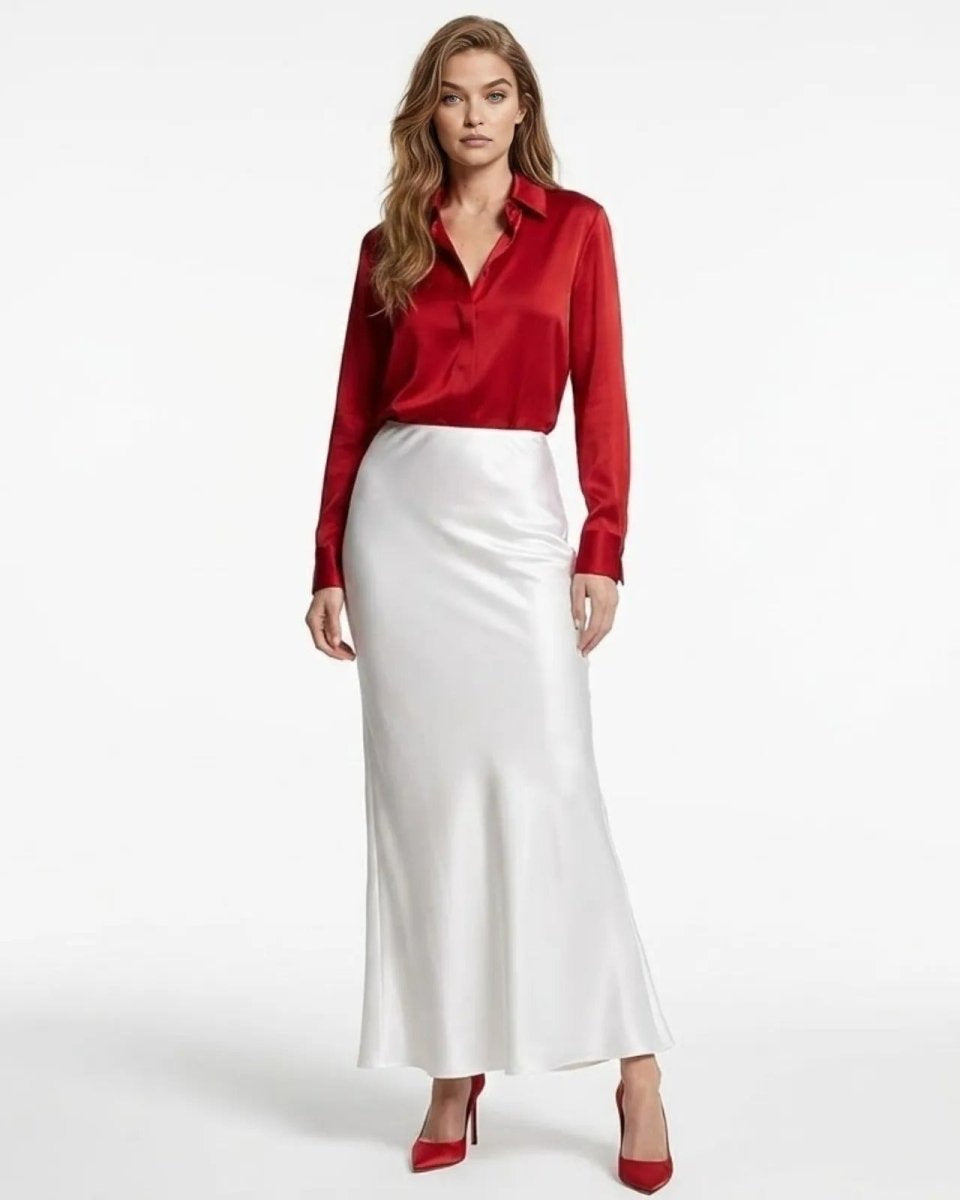 Model wearing the white silk maxi skirt, styled with a red blouse, demonstrating its elegant, fluid drape from the front.