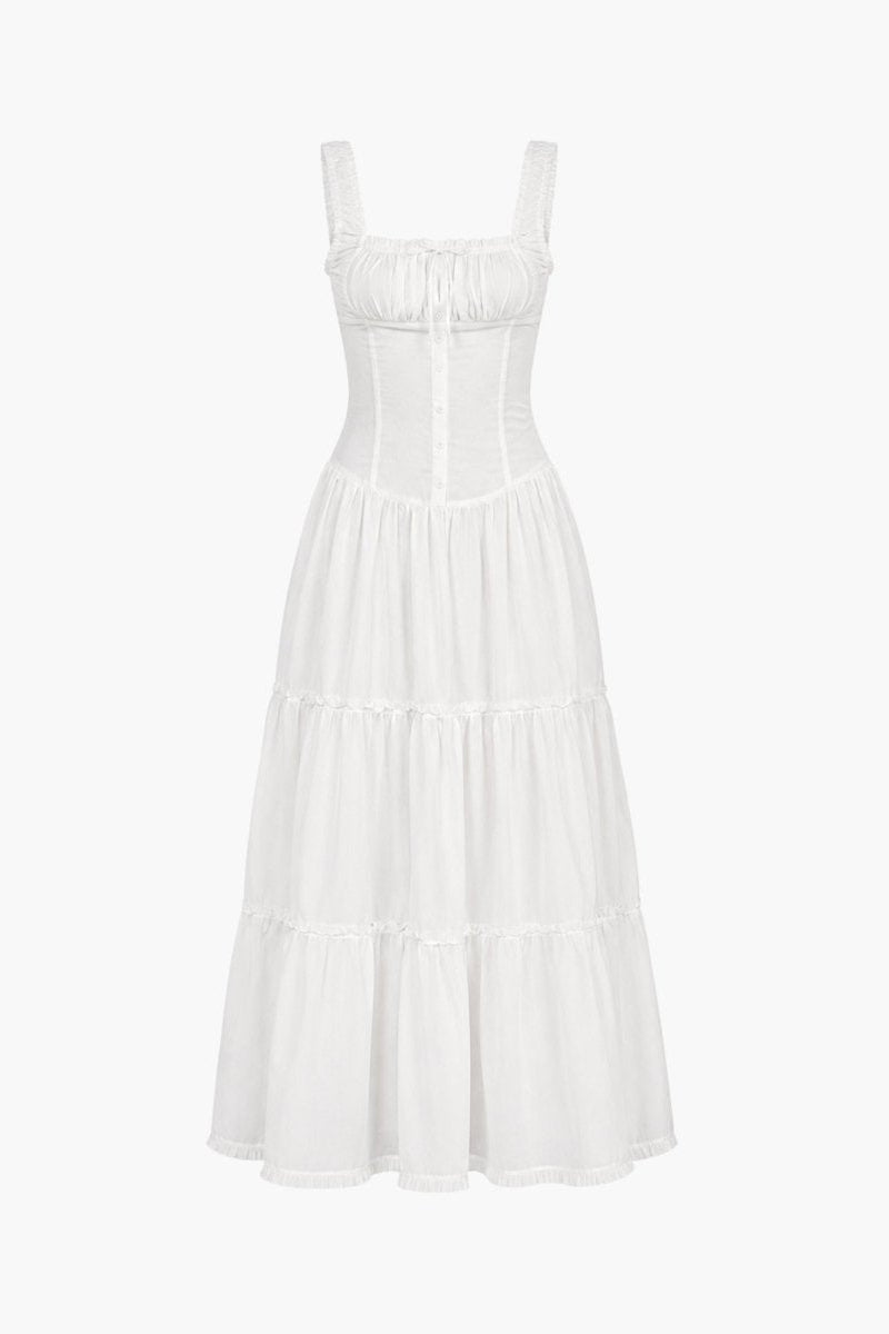 Flat lay front view of a white resort wear dress featuring a square neckline, ruched bust with tie, and button down corset bodice.