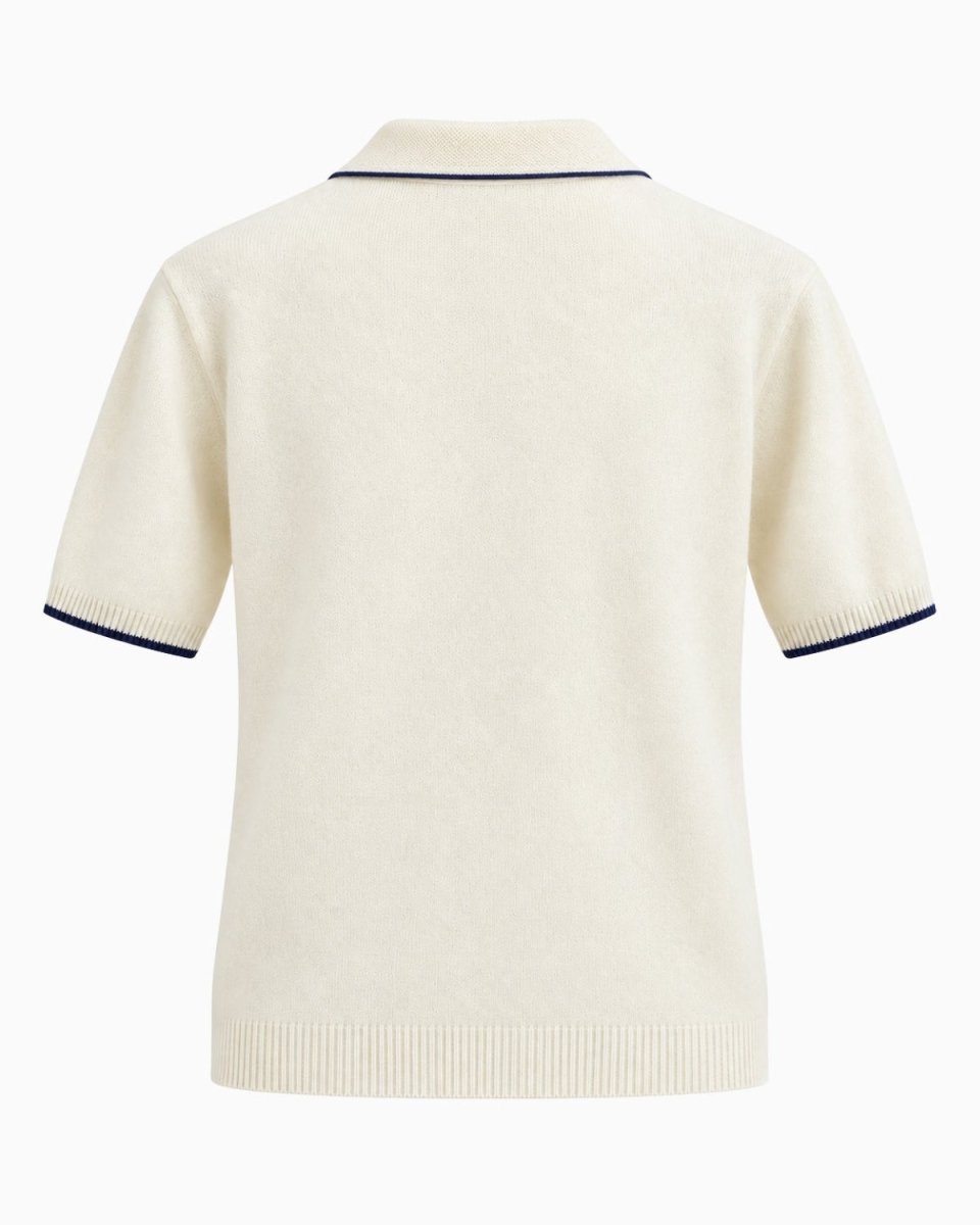 A cream-colored short-sleeve knit polo shirt shown from the back, featuring thin navy blue piping along the collar and sleeve cuffs.