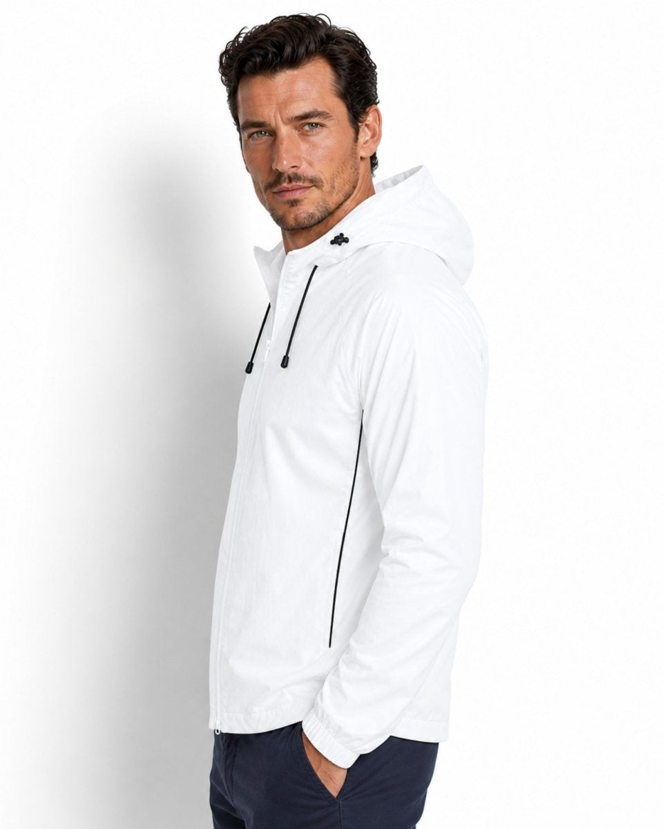Side profile of man wearing white athleisure jacket with black contrast piping by Kouvr