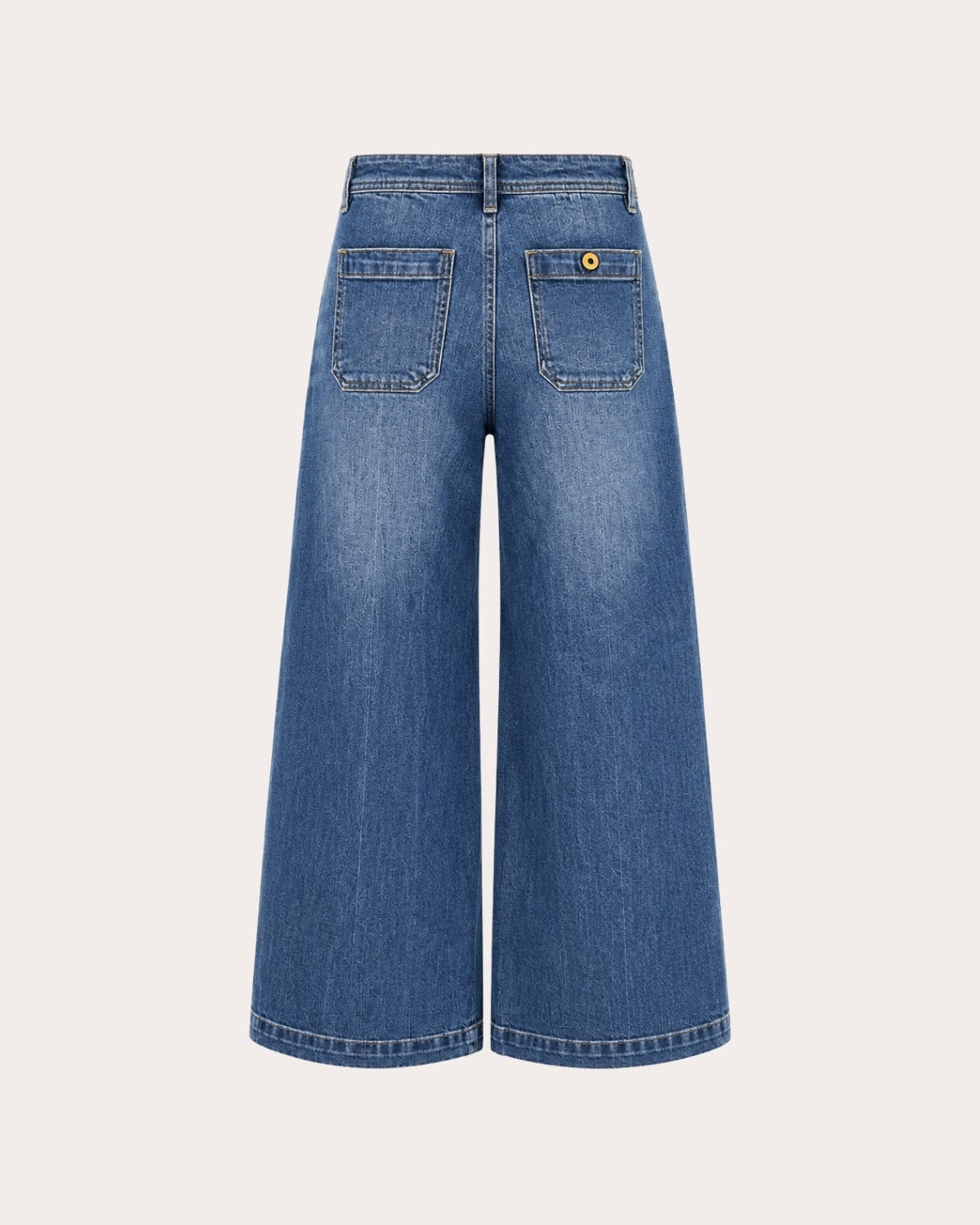 Back flatlay studio shot of vintage blue wide leg jeans showing back pocket placement, button closure, and wide flared leg opening.