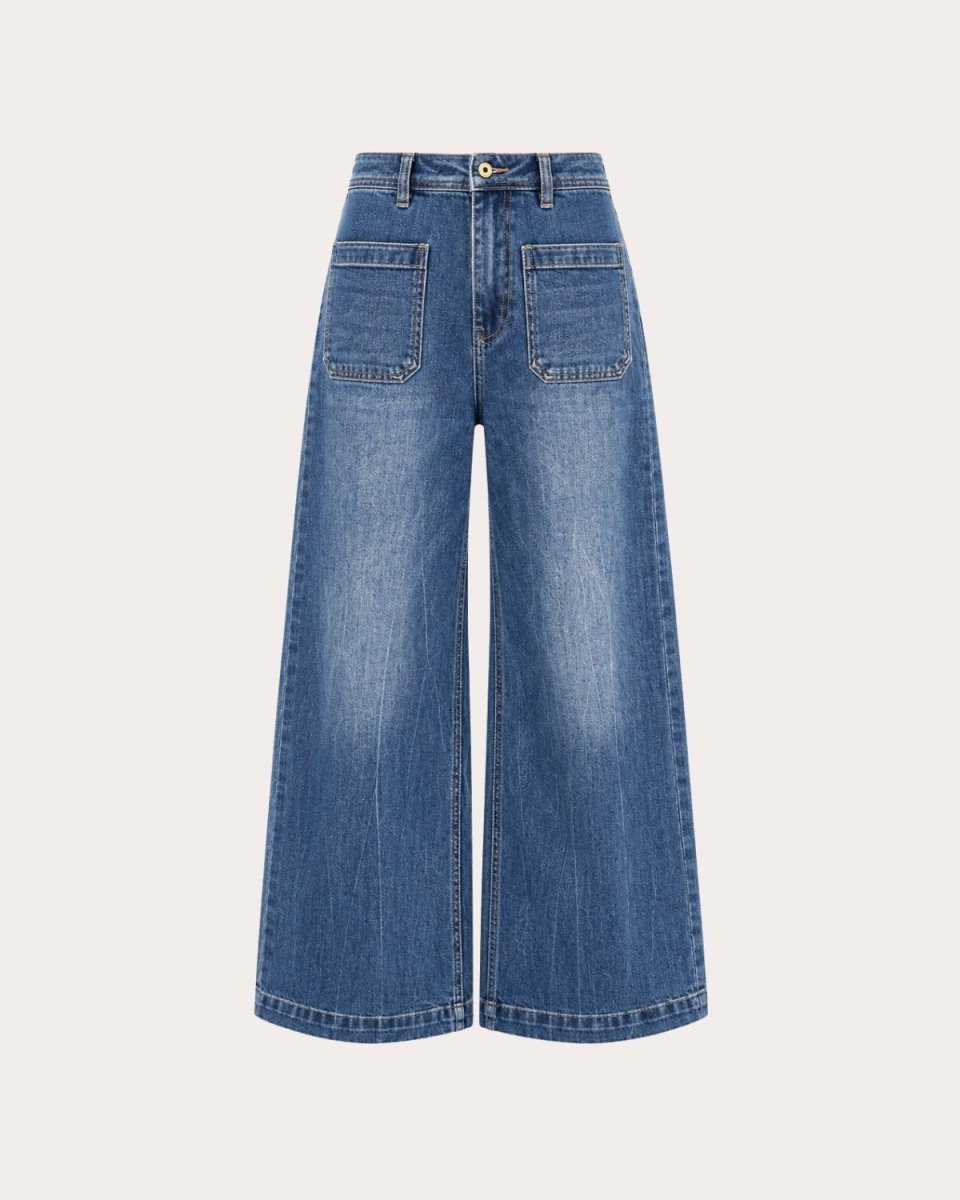 Front flatlay studio shot of medium blue wide leg denim jeans emphasizing the high waist construction and front pocket detailing.