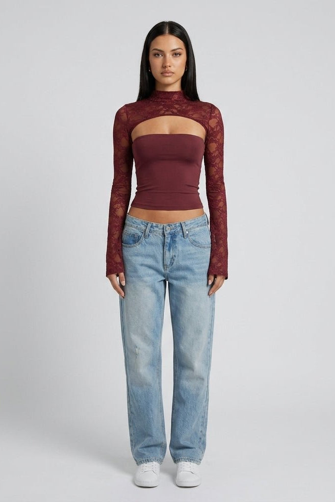Full body style view of model wearing Kouvr wine red lace mock neck top with light wash denim jeans