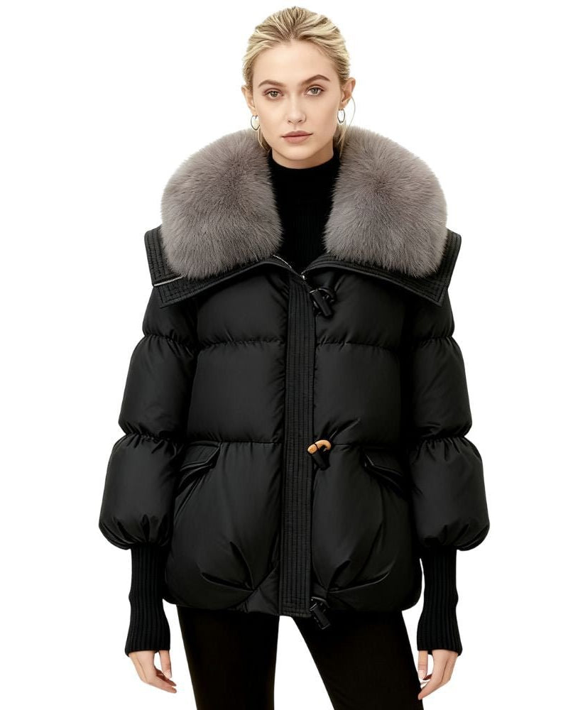 Black fenlo form puffer coat with fur collar worn by a model on a white background