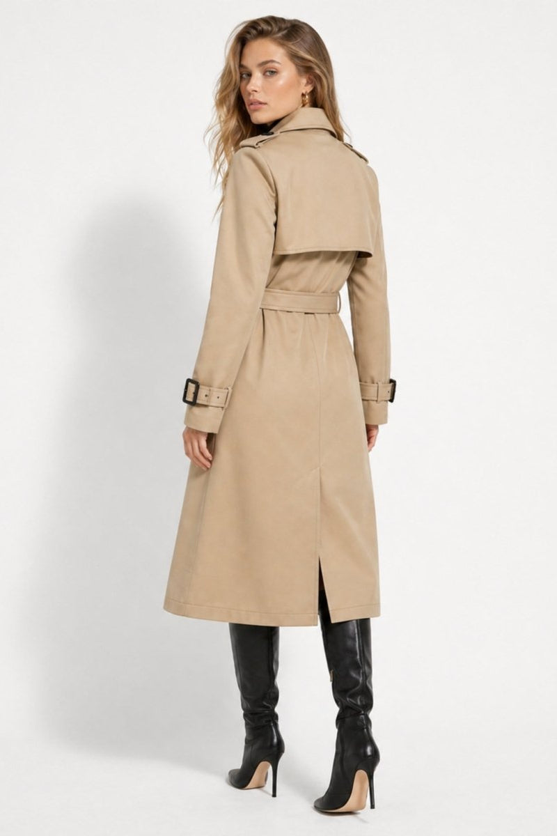 Back view of a tailored khaki trench coat showing the classic storm flap, waist belt, and deep back vent