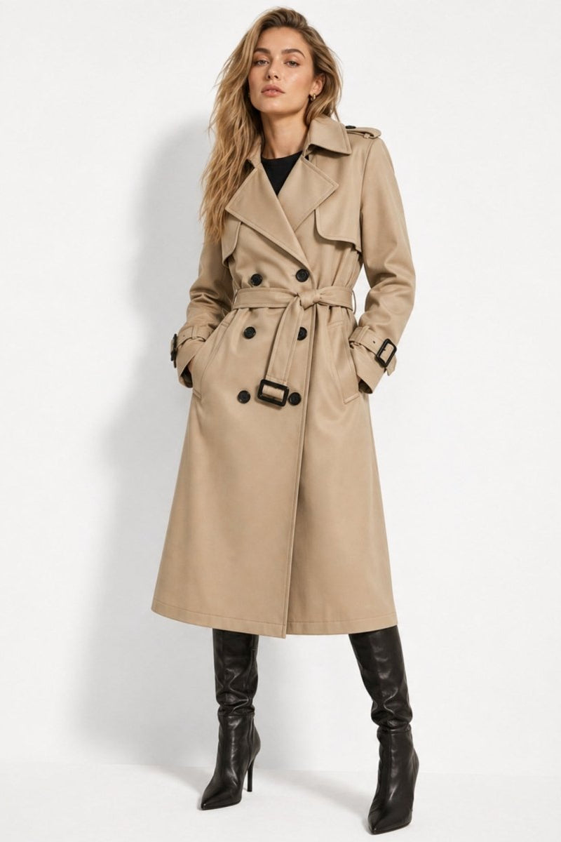 Female model posing with hands in pockets wearing a stylish khaki trench coat with adjustable waist belt
