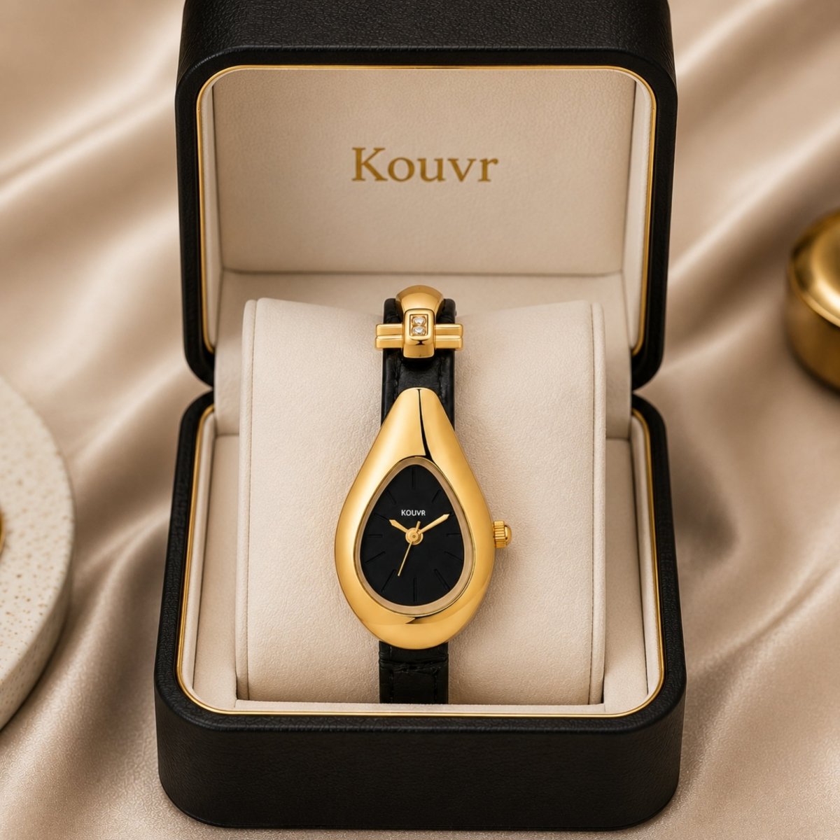  Kouvr women's vintage style teardrop gold watch with black leather strap displayed in premium black presentation gift box on silk