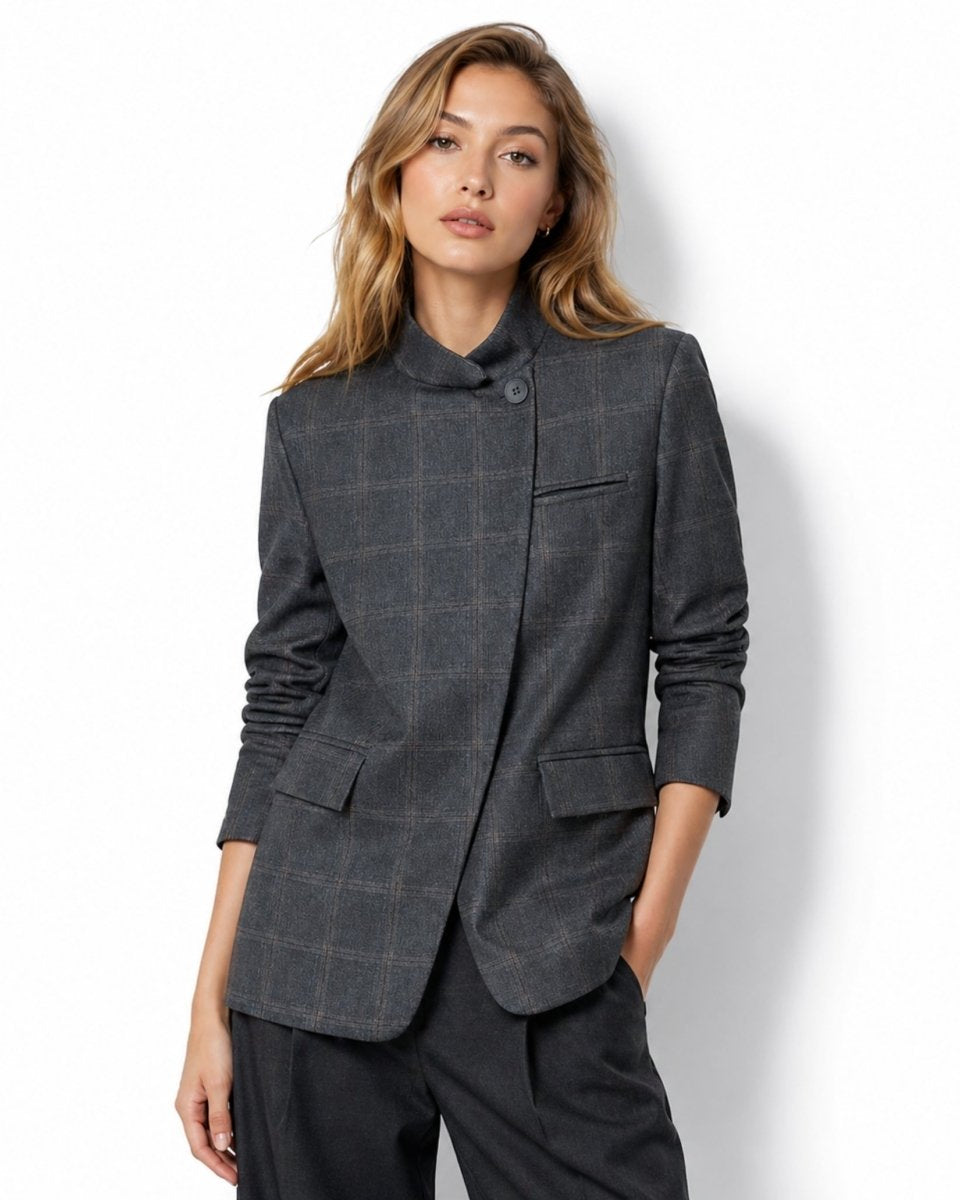 Three quarter view of the grey plaid blazer highlighting the flap pockets and high collar design.