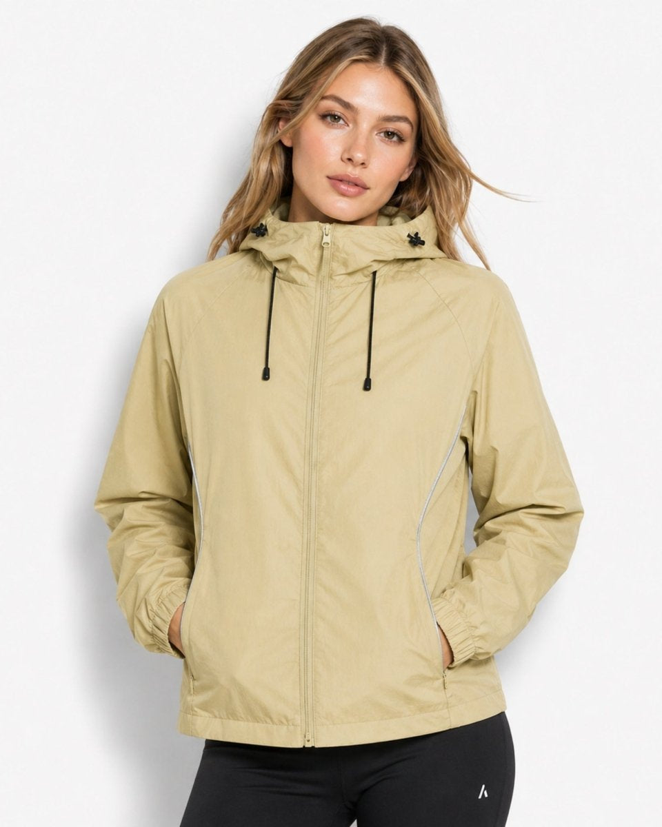 Woman modeling the versatile unisex light army green water-resistant zip-up rain shell jacket