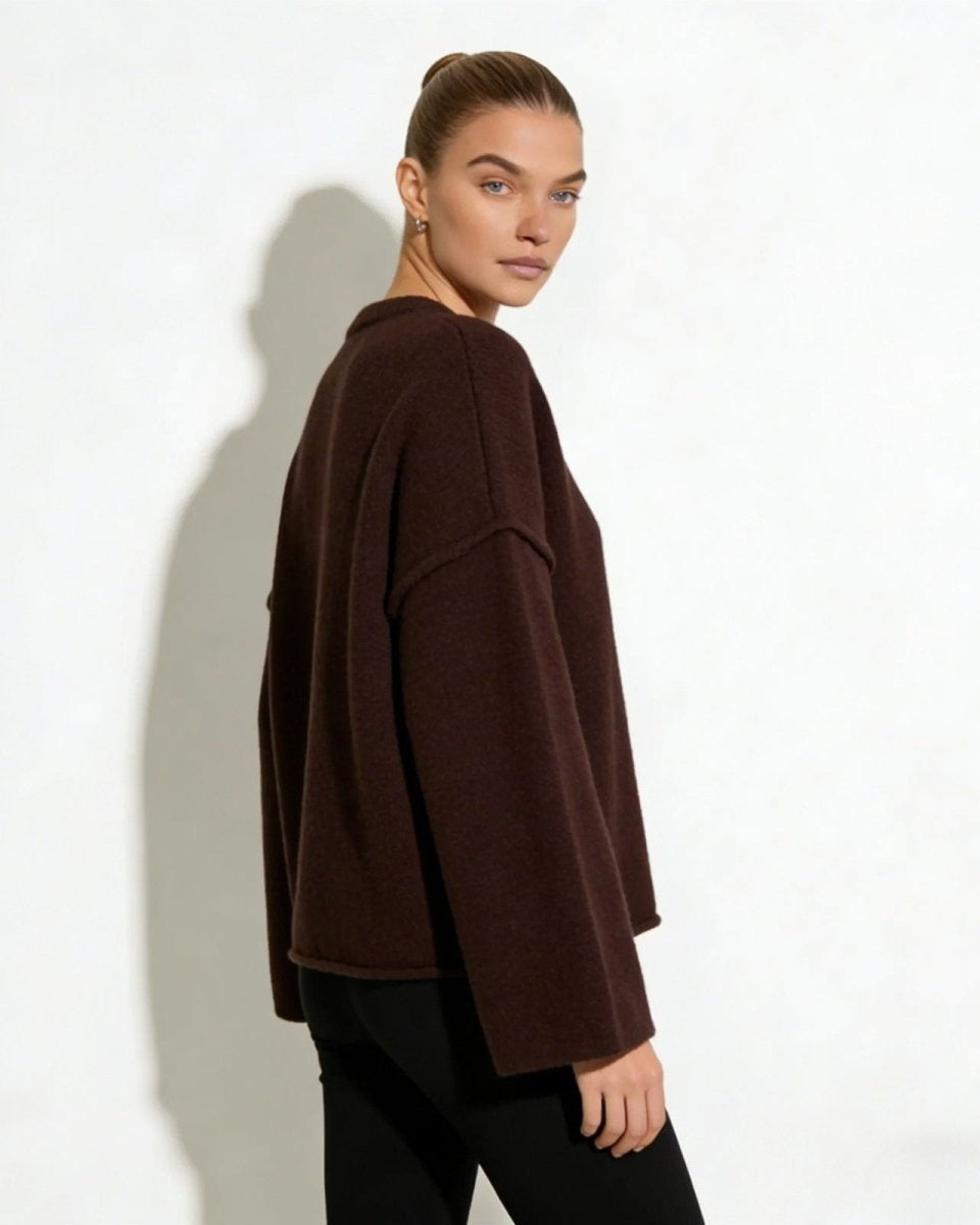 Side profile of a model in the dark brown wide-sleeve sweater.