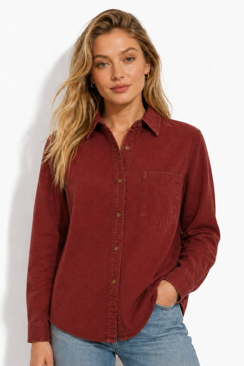 Woman modeling the green-long-sleeve-button-down-shirt-womens-front red brushed cotton button down shirt styled with light wash jeans, half tucked with hands in pockets.
