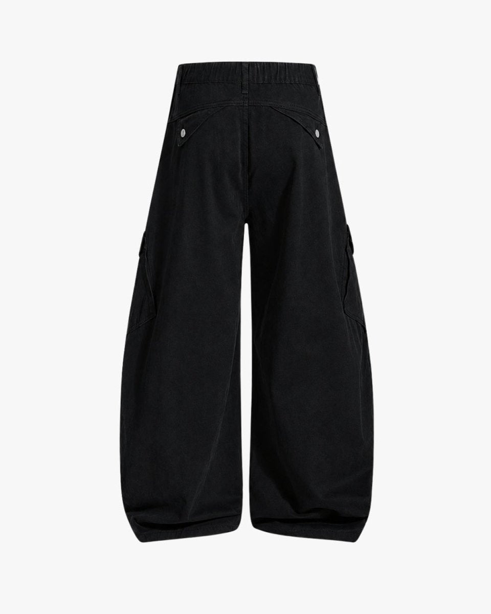 Black wide-leg cargo pants shown from the back, featuring an elastic waistband and flap cargo pockets with silver snap buttons, on a light gray background.