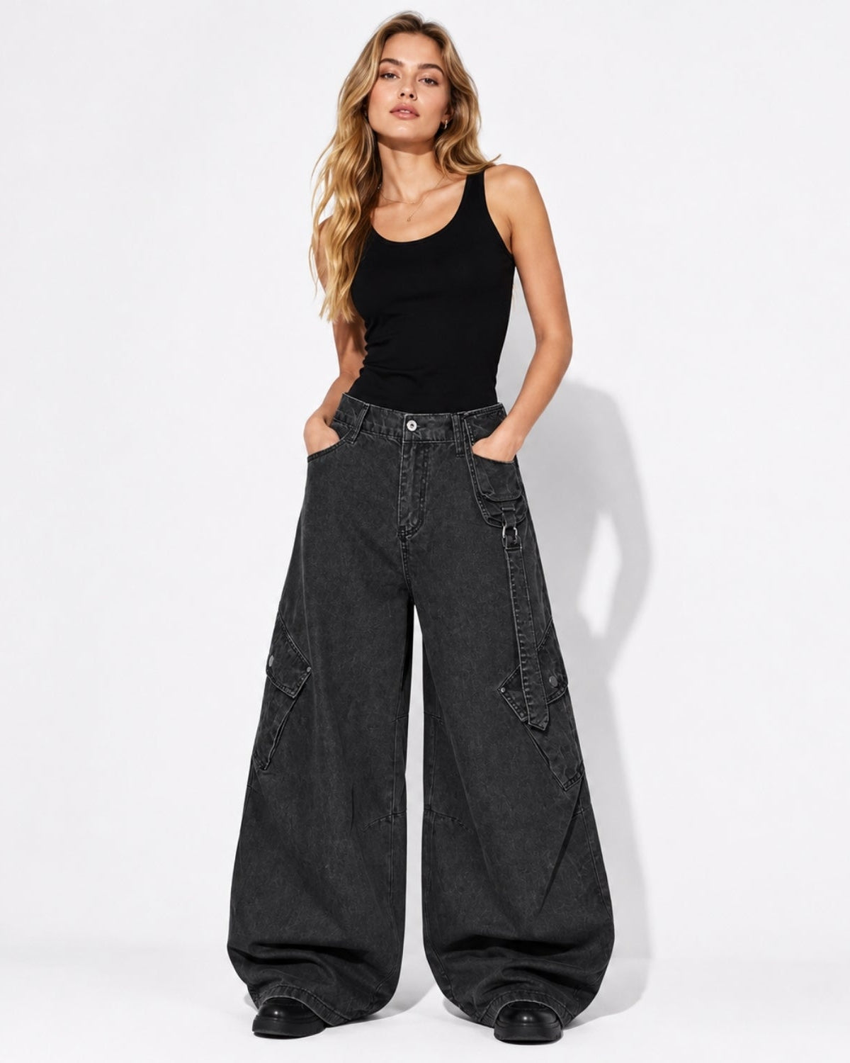 Woman wearing washed green oversized Y2K baggy cargo pants with wide leg parachute fit and styling tank top