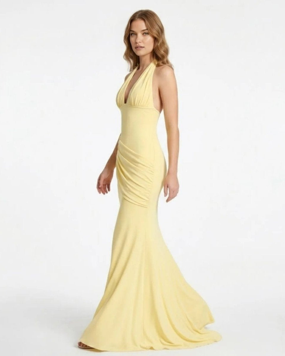 Side profile of the Fenlo yellow formal maxi dress highlighting the asymmetrical ruched hip detailing and elegant fitted silhouette.