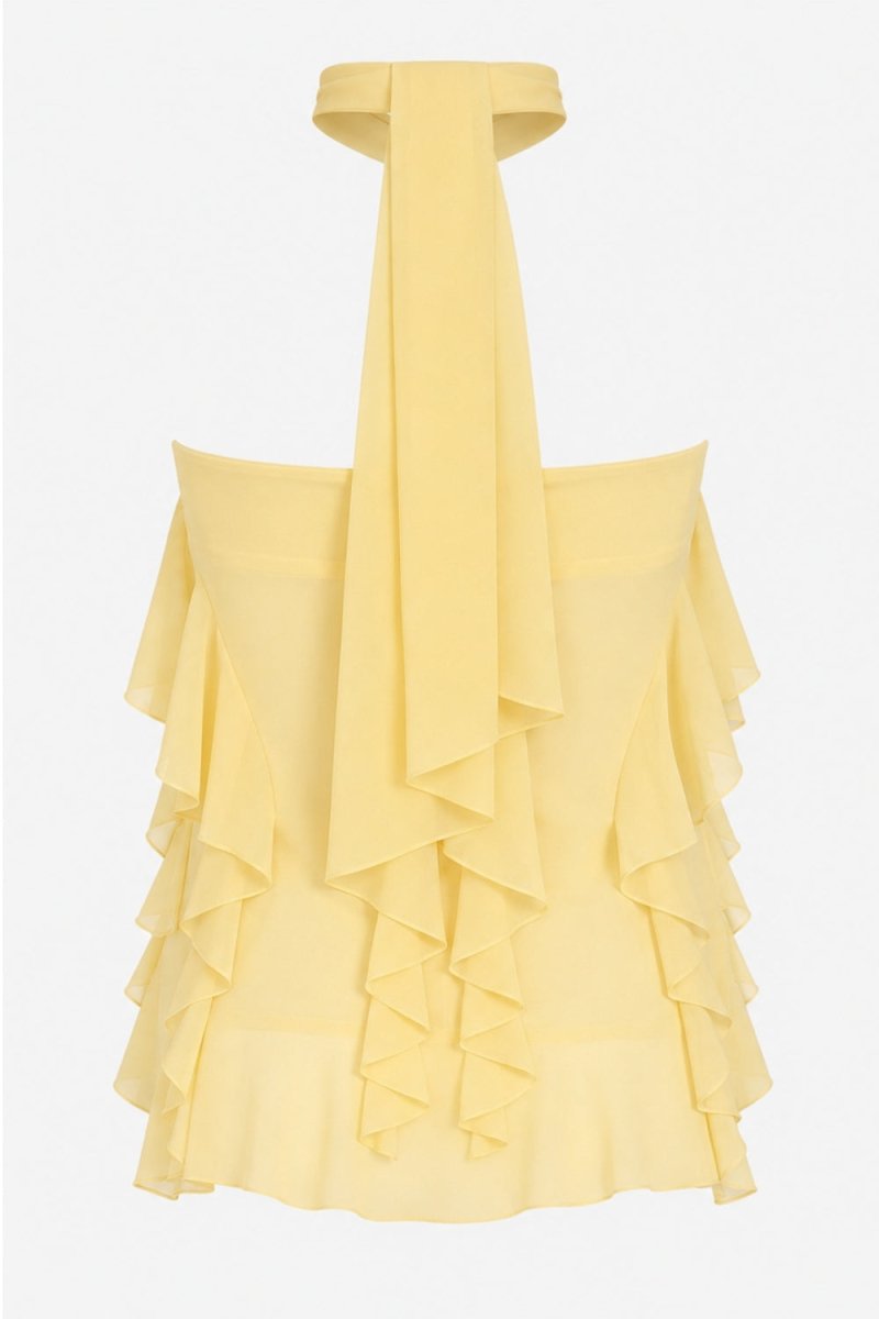 A pale yellow ruffled halter dress with a long draped tie at the neckline, shown against a plain light gray background.