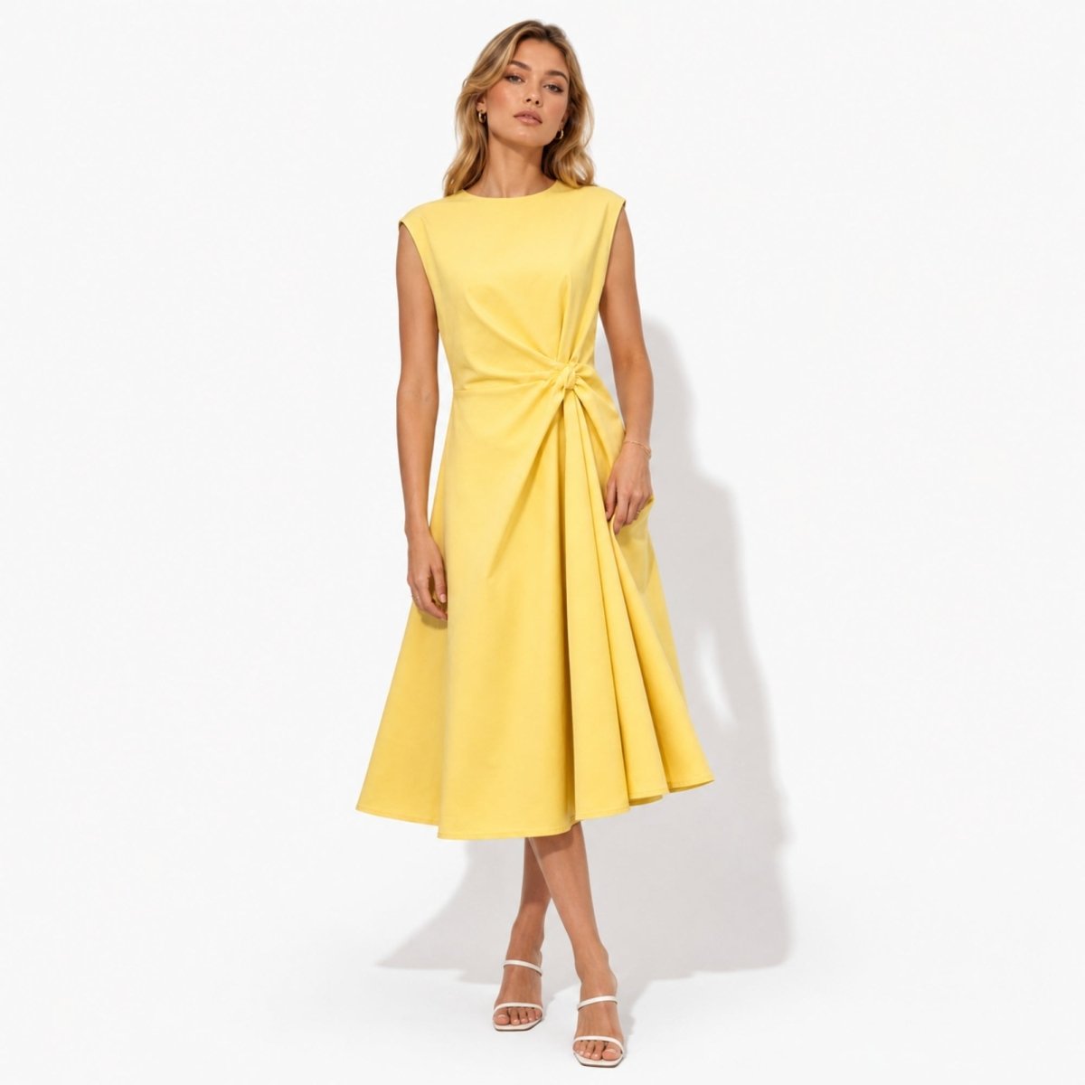Front view of woman wearing Kouvr elegant yellow sleeveless midi dress featuring a flattering twist knot waist and flared A-line skirt.