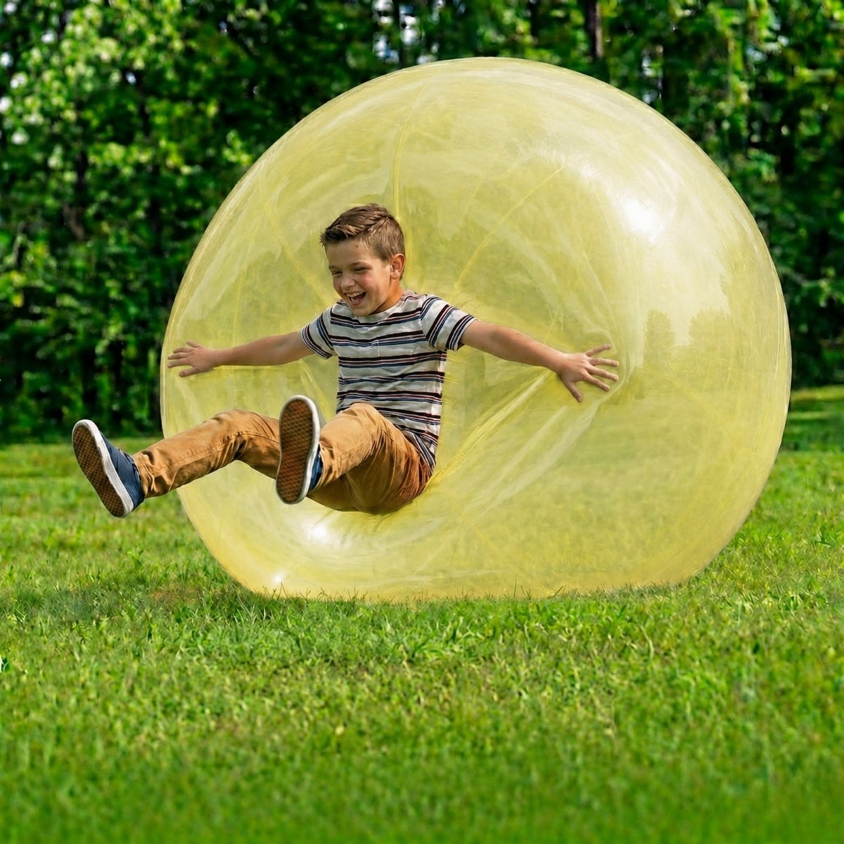 A smiling boy bouncing on a yellow giant bubble ball that expands to 110cm, featuring text about the buy one get one free special offer.