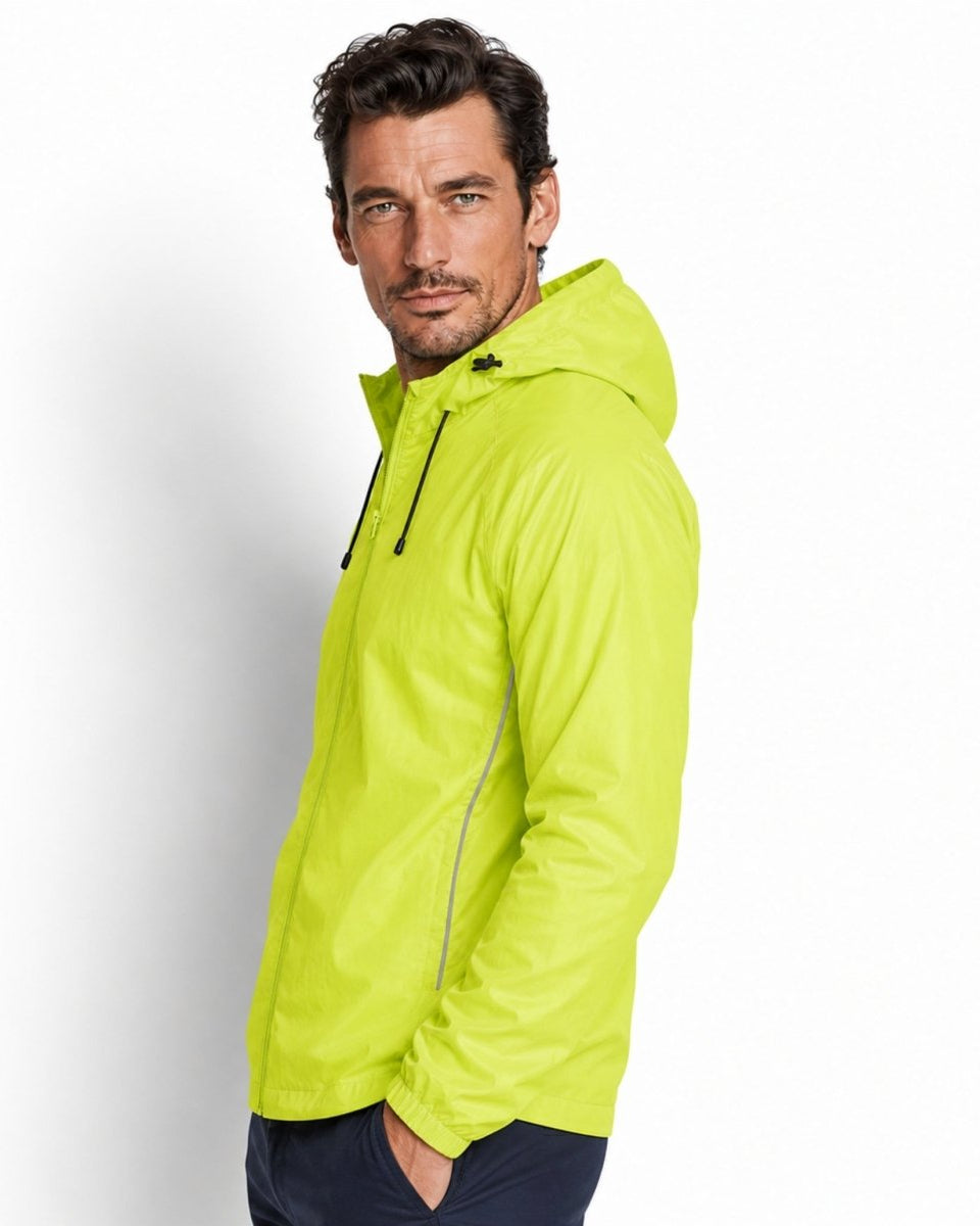 Side view of male model in yellow water-resistant activewear jacket highlighting raglan sleeves