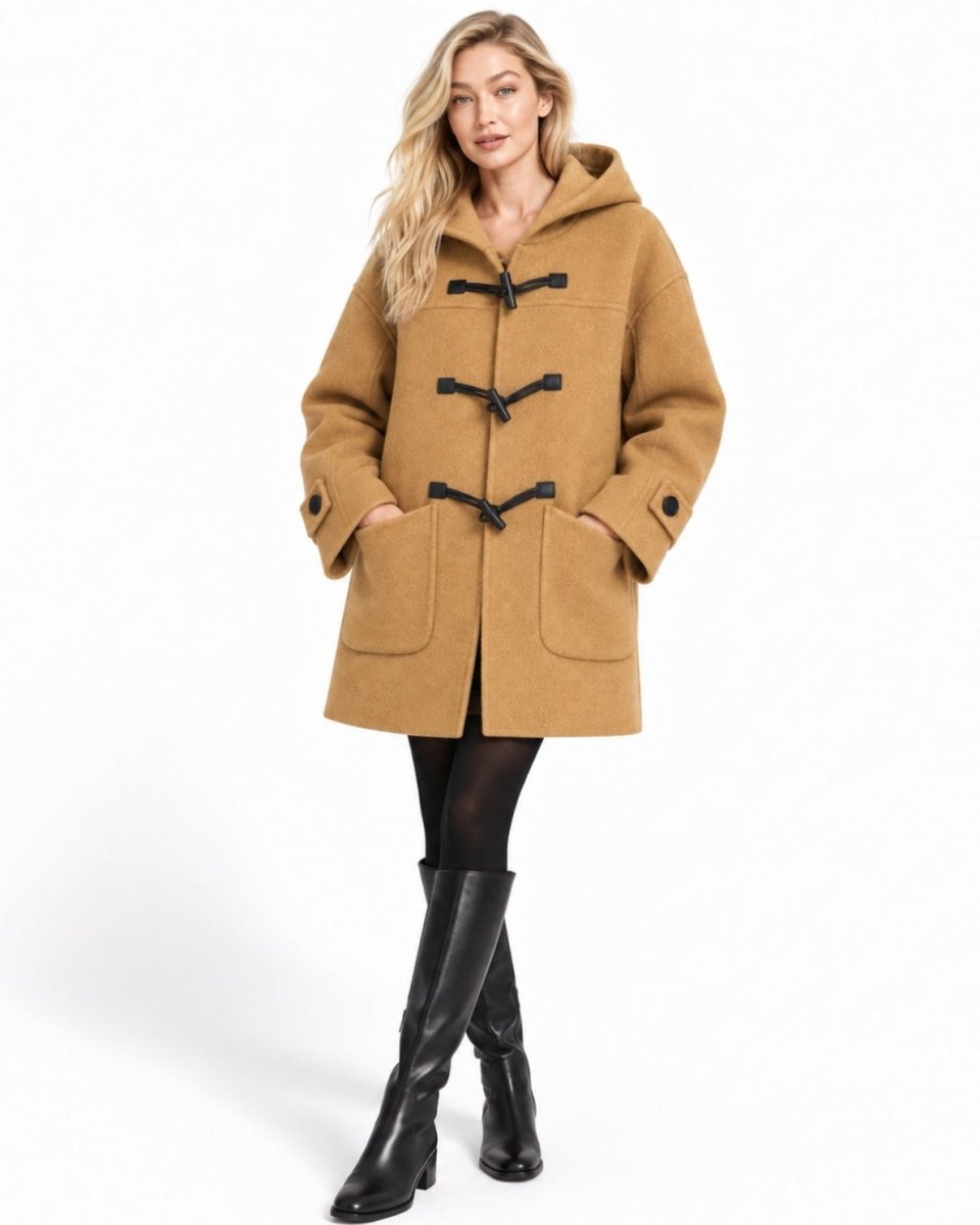 Woman wearing luxury oversized wool duffle coat with hood and toggles facing forward.